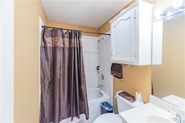 full bathroom featuring vanity, shower / bath combination with curtain, a textured ceiling, and toilet