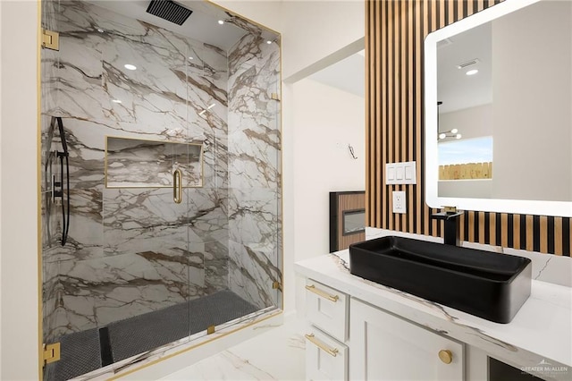 bathroom with vanity and a shower with shower door