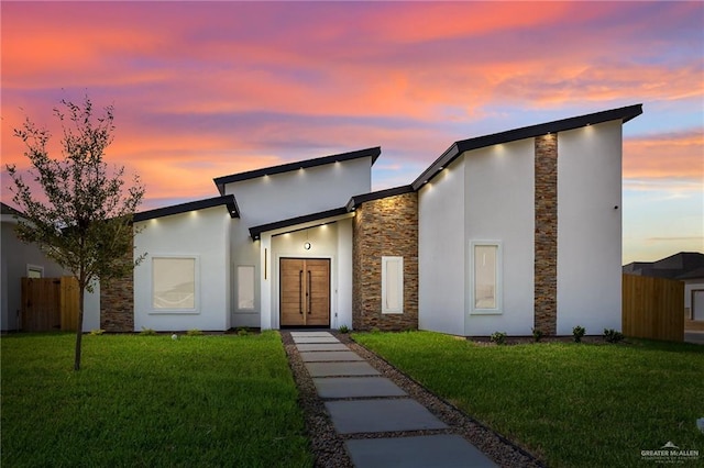 contemporary home with a yard