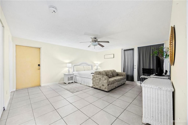 6300 Padre Blvd Unit 871, South Padre Island, TX 78597 - bedroom featuring light tile patterned flooring, a textured ceiling, ceiling fan, and access to exterior