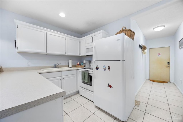 6300 Padre Blvd Unit 871, South Padre Island, TX 78597 - kitchen featuring white appliances, light tile patterned floors, light countertops, and white cabinetry