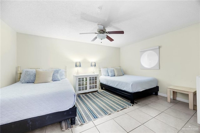 6300 Padre Blvd Unit 871, South Padre Island, TX 78597 - bedroom featuring light tile patterned floors, ceiling fan, and a textured ceiling