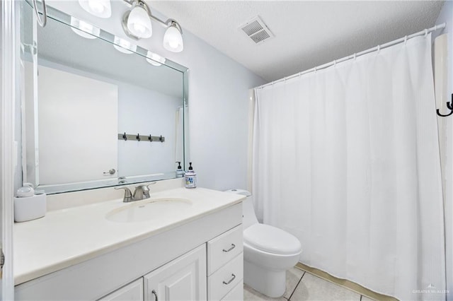 6300 Padre Blvd Unit 871, South Padre Island, TX 78597 - bathroom featuring vanity, tile patterned floors, and a textured ceiling