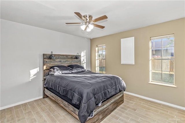 bedroom with ceiling fan and multiple windows