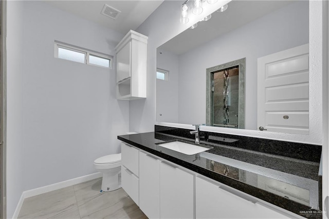 bathroom with vanity, toilet, and walk in shower