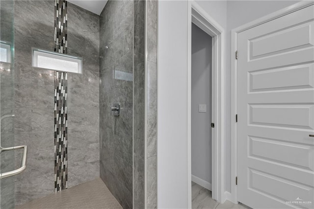 bathroom with a shower with door