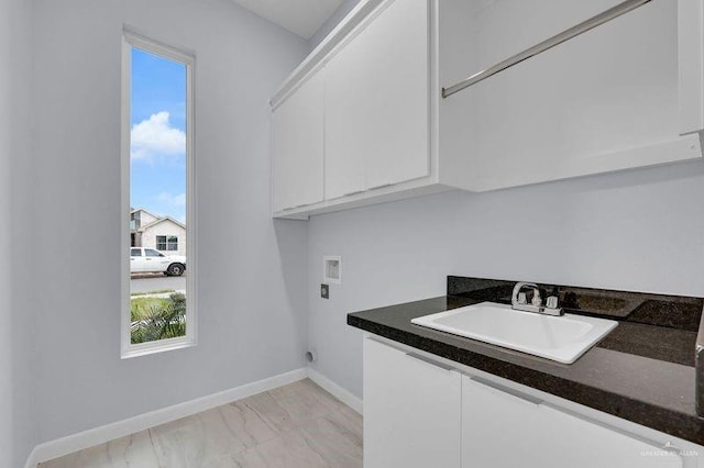 washroom featuring cabinets, sink, and hookup for a washing machine