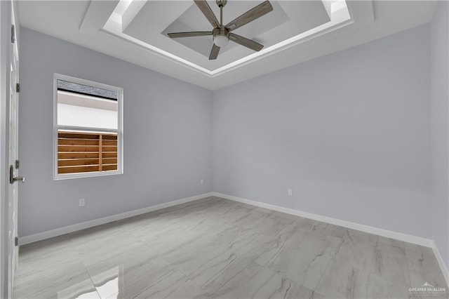 unfurnished room featuring a tray ceiling and ceiling fan