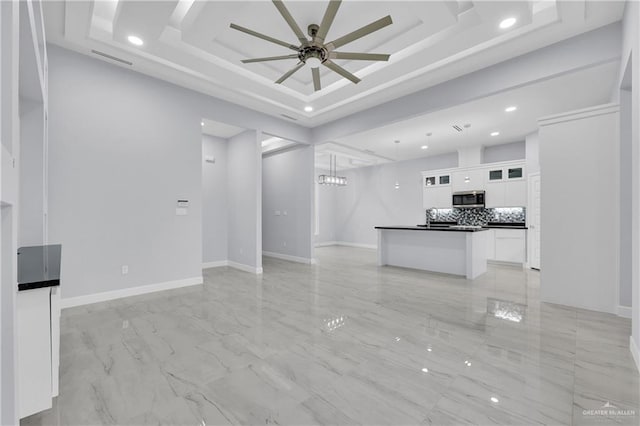 unfurnished living room featuring ceiling fan