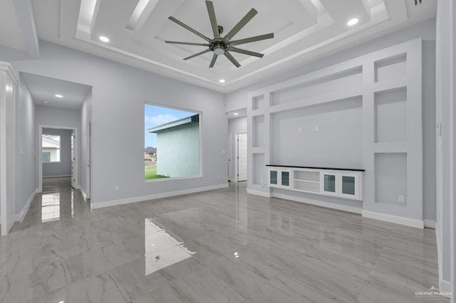 unfurnished living room featuring ceiling fan and a high ceiling