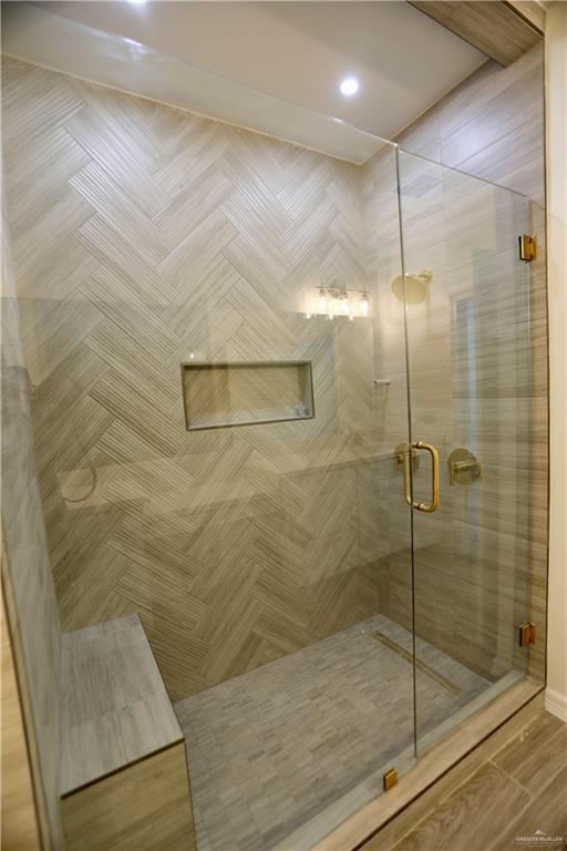 bathroom with a shower with door