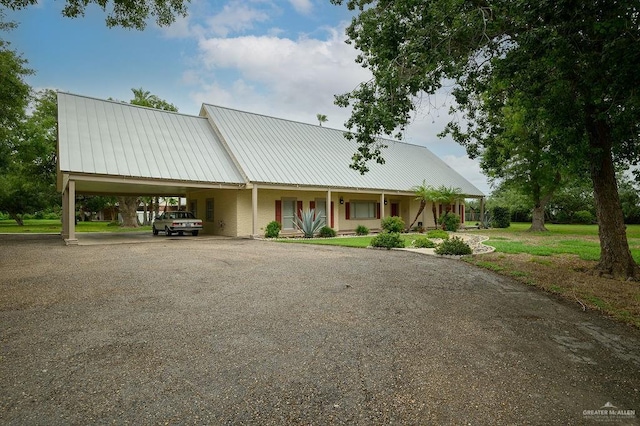 view of front of property featuring covered porch and a carport