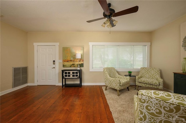 sitting room featuring ceiling fan and dark hardwood / wood-style floors