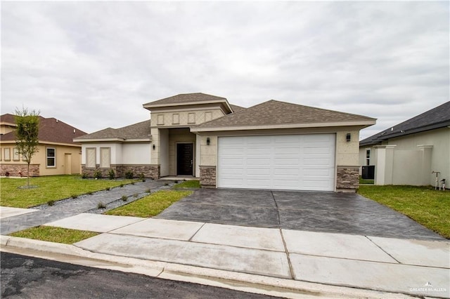 prairie-style house with a front yard and a garage