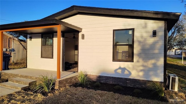 view of side of property with central AC unit