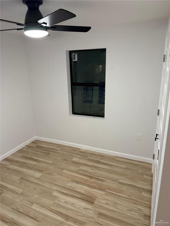 empty room with a ceiling fan, baseboards, and light wood finished floors