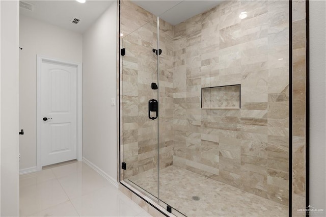 bathroom with tile patterned floors and a shower with shower door