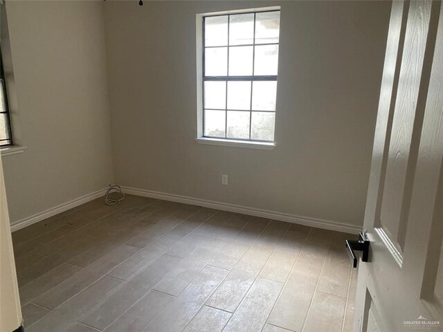 empty room featuring light hardwood / wood-style flooring and a healthy amount of sunlight