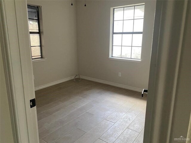 unfurnished room featuring light hardwood / wood-style floors and a healthy amount of sunlight