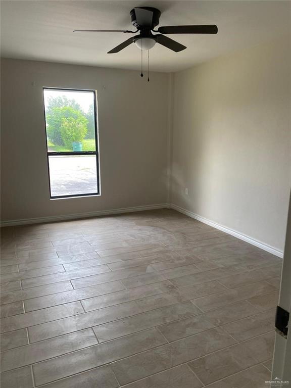 spare room featuring ceiling fan and wood-type flooring