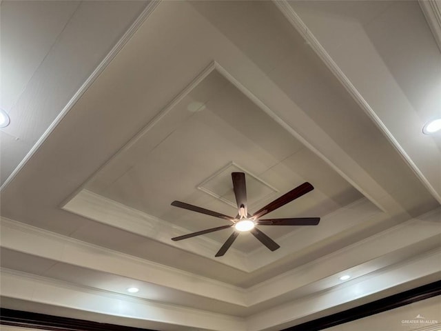 detailed view of a raised ceiling, ornamental molding, a ceiling fan, and recessed lighting