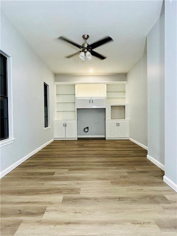 915 Durango St, Mission, TX 78572 - unfurnished living room with built in features, baseboards, a ceiling fan, and wood finished floors