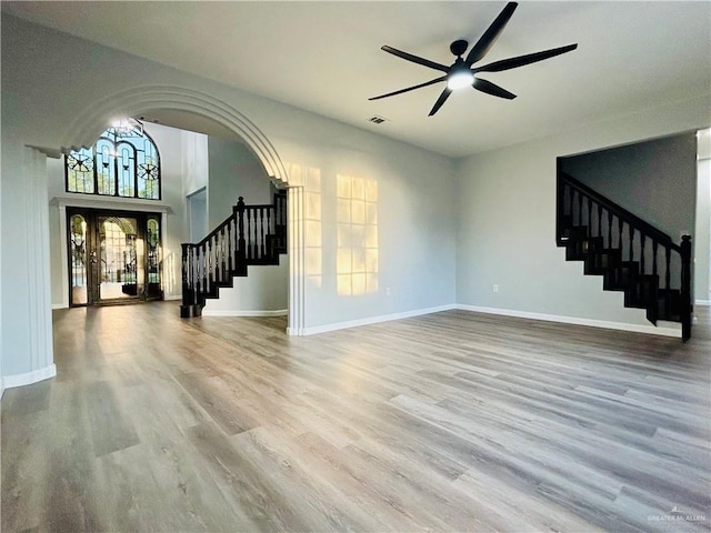 915 Durango St, Mission, TX 78572 - unfurnished living room featuring visible vents, baseboards, a ceiling fan, stairway, and wood finished floors