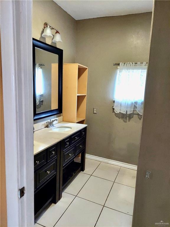 bathroom featuring tile patterned flooring and vanity