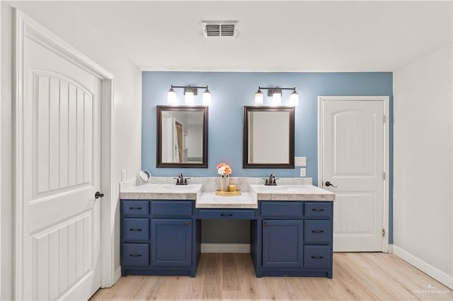 23807 Stuart Place Rd, Harlingen, TX 78552 - bathroom featuring double vanity and wood finished floors