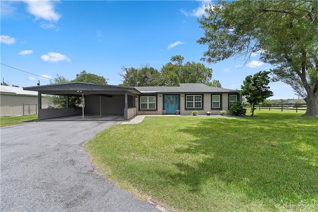 23807 Stuart Place Rd, Harlingen, TX 78552 - ranch-style home featuring asphalt driveway and a carport