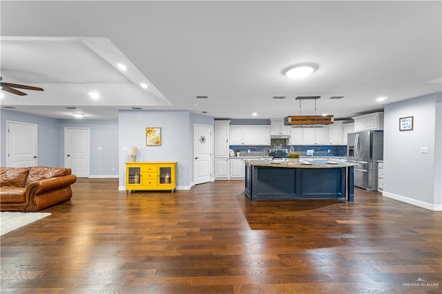 23807 Stuart Place Rd, Harlingen, TX 78552 - kitchen with appliances with stainless steel finishes, open floor plan, a kitchen island, white cabinetry, and recessed lighting