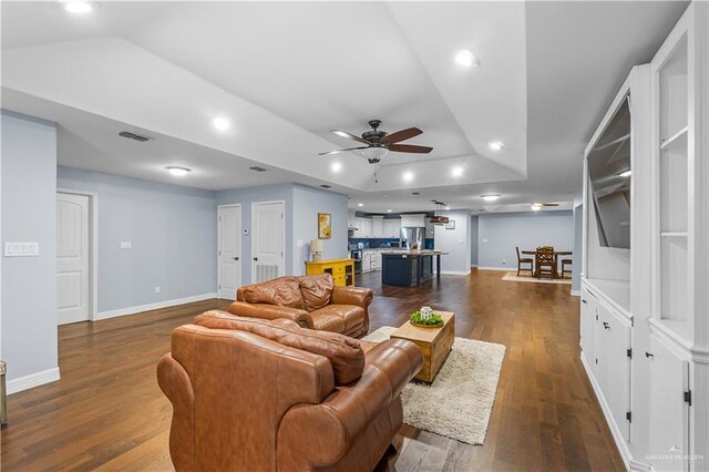 23807 Stuart Place Rd, Harlingen, TX 78552 - living room featuring a ceiling fan, dark wood finished floors, a raised ceiling, and recessed lighting