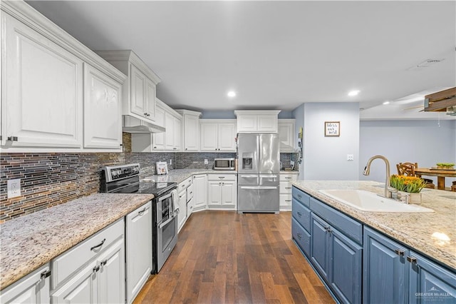 23807 Stuart Place Rd, Harlingen, TX 78552 - kitchen featuring stainless steel appliances, blue cabinetry, white cabinets, recessed lighting, and backsplash