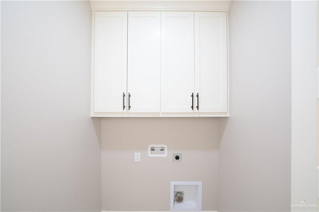 washroom with cabinet space, hookup for a washing machine, and electric dryer hookup