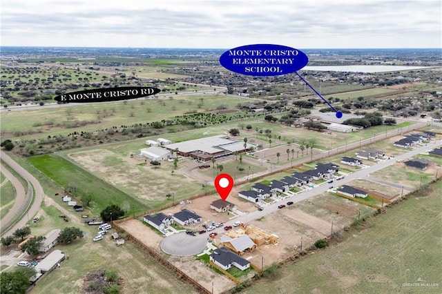 birds eye view of property with a rural view