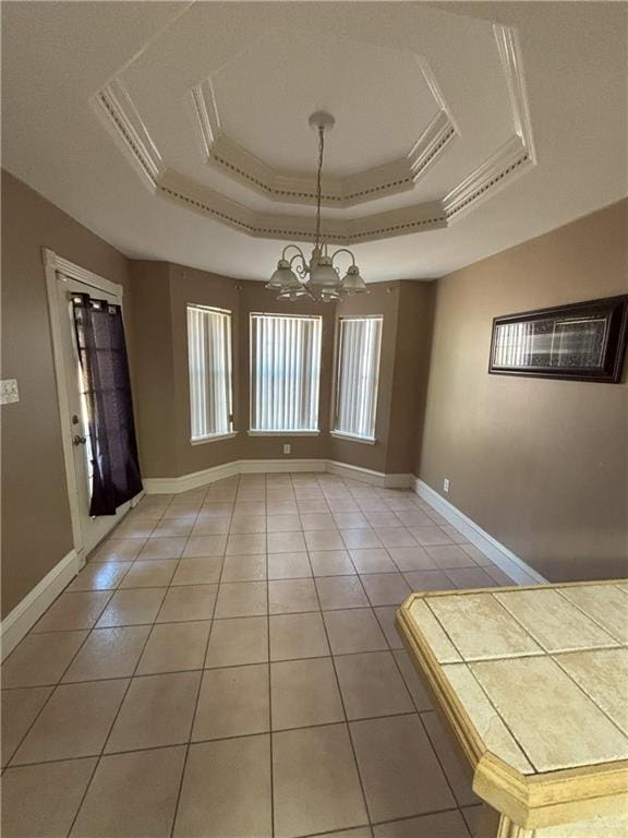 unfurnished dining area featuring a raised ceiling, tile patterned floors, and an inviting chandelier