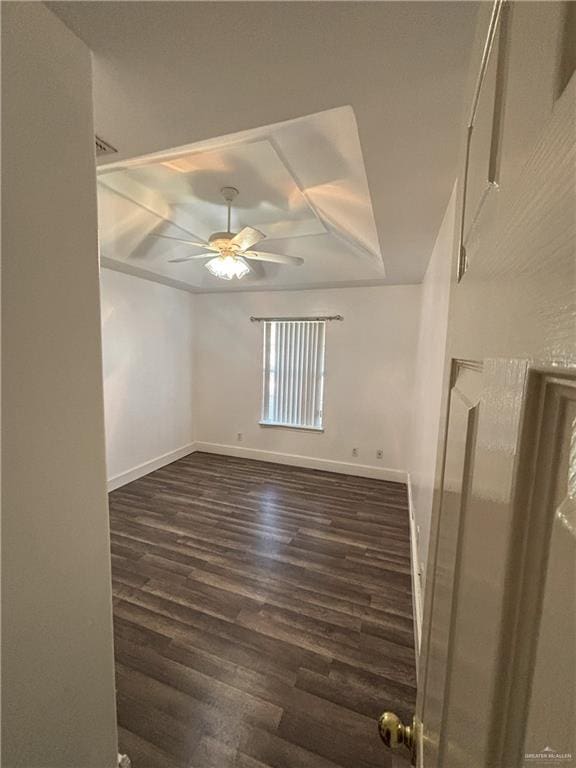 spare room with ceiling fan and dark hardwood / wood-style floors