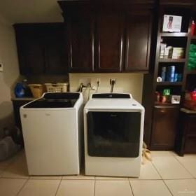 4907 N 25th Ln, Mcallen, TX 78504 - laundry room with washing machine and dryer, cabinet space, and light tile patterned flooring