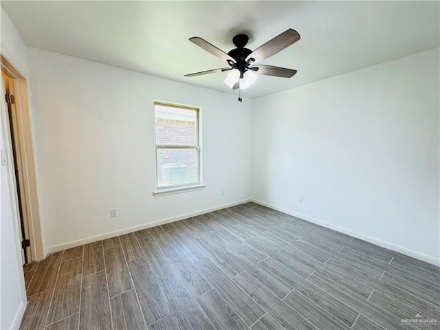 606 S Paseo Del Rey St, Mission, TX 78572 - empty room featuring dark wood finished floors, ceiling fan, and baseboards