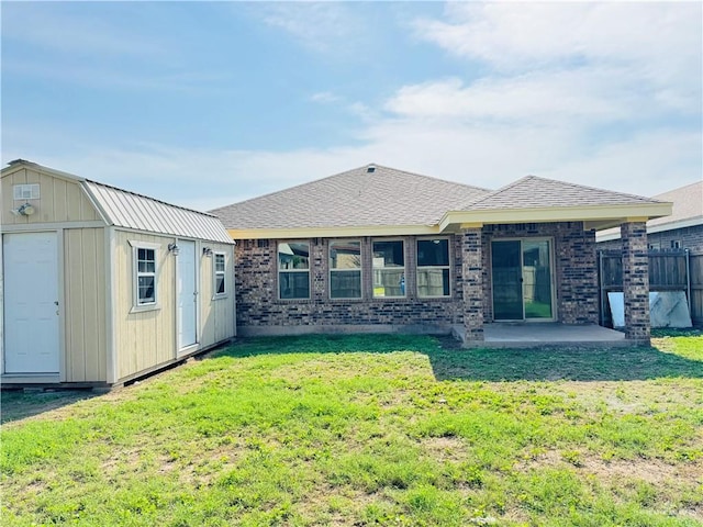 606 S Paseo Del Rey St, Mission, TX 78572 - rear view of house featuring a storage shed, an outdoor structure, a patio, and brick siding