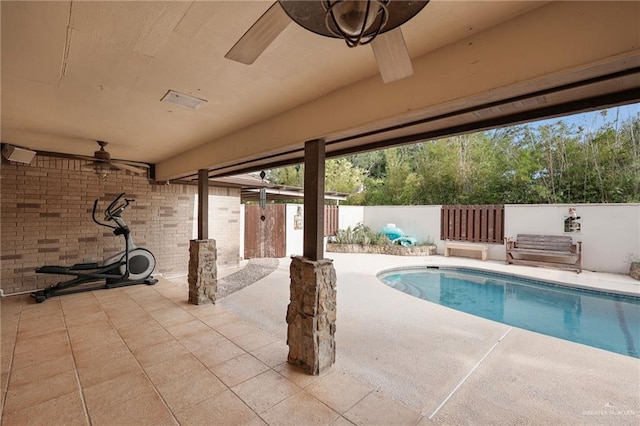 view of pool with ceiling fan, a patio area, and a fenced backyard