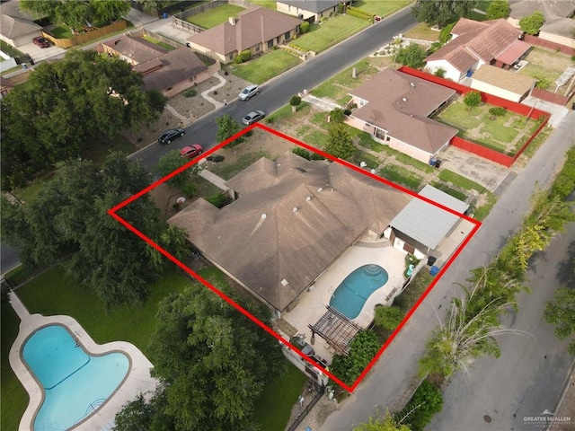 aerial view of residential area with a pool area and property boundaries highlighted