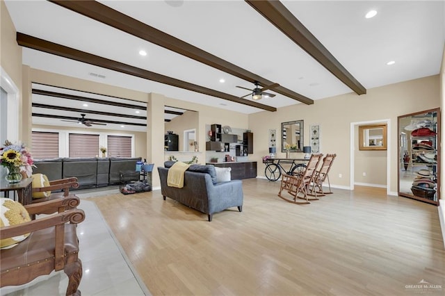 living area with a ceiling fan, beamed ceiling, baseboards, light wood-type flooring, and recessed lighting