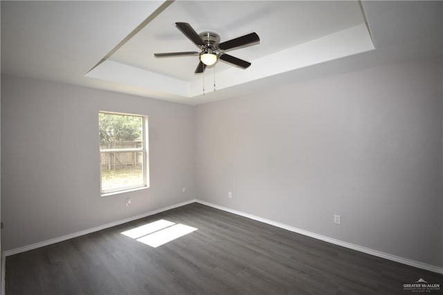 2816 N 40th St, Mcallen, TX 78501 - unfurnished room with a raised ceiling, dark wood-type flooring, and baseboards
