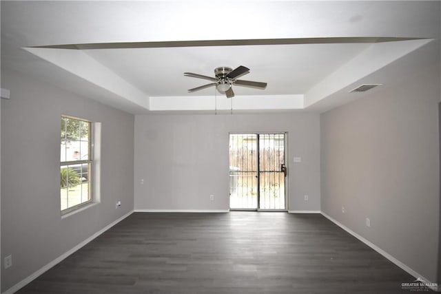2816 N 40th St, Mcallen, TX 78501 - spare room featuring a raised ceiling, dark wood-type flooring, a ceiling fan, and baseboards