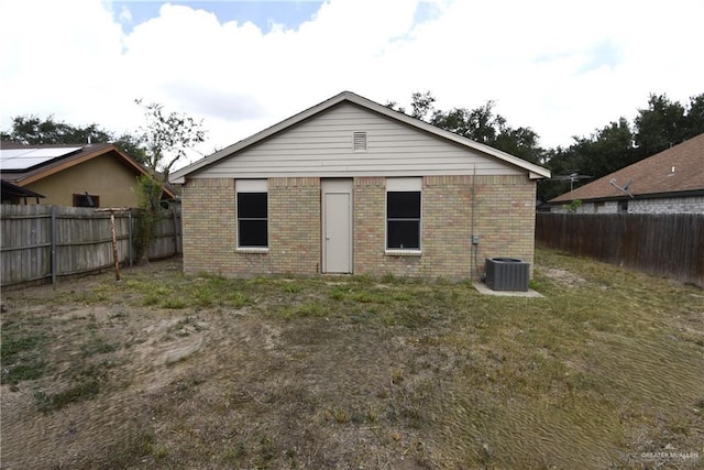 2816 N 40th St, Mcallen, TX 78501 - back of house featuring brick siding, a fenced backyard, and central AC unit