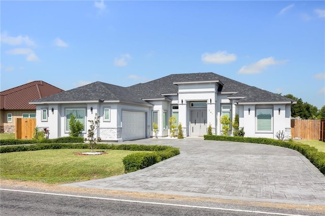 view of front of house with a front lawn and a garage