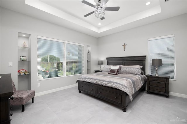 bedroom featuring a tray ceiling and ceiling fan