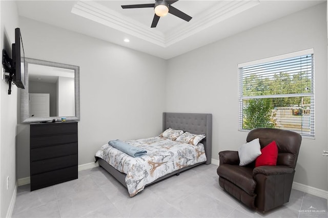 tiled bedroom featuring a tray ceiling, ceiling fan, and crown molding