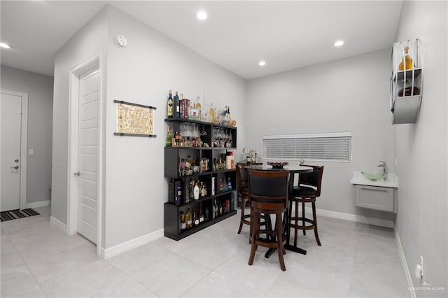 tiled dining room with indoor bar